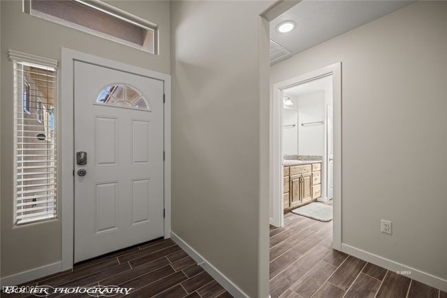 Entryway with wood finish floors and baseboards | Image 10