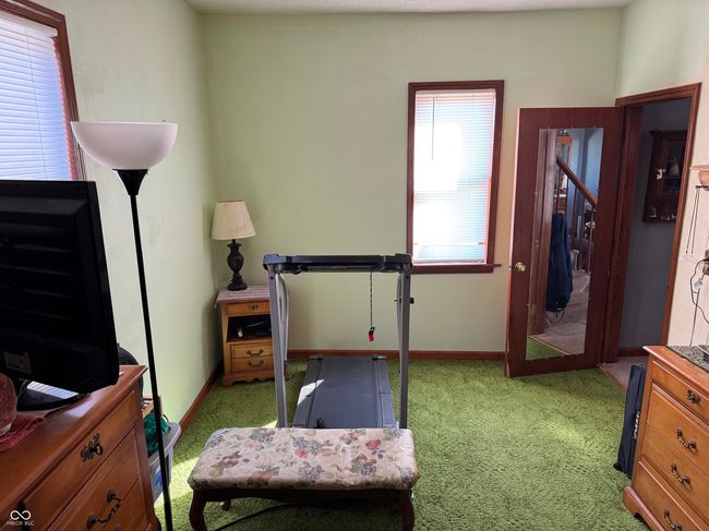 workout room featuring light colored carpet and baseboards | Image 29