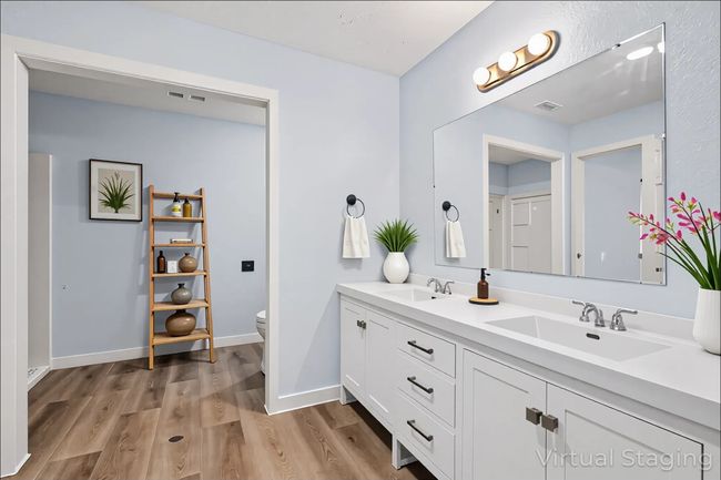 Full bathroom featuring double vanity and wood finished floors | Image 22
