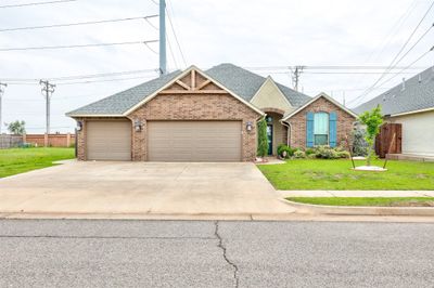 View of front of home featuring a garage and a front yard | Image 1