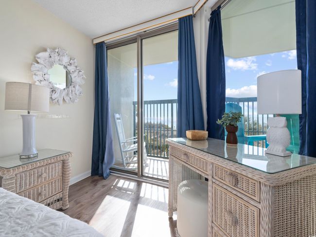 Bedroom with baseboards, a textured ceiling, wood finished floors, and access to outside | Image 25