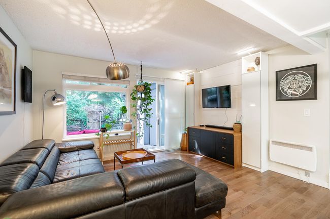 Living area with wood finished floors and a textured ceiling | Image 7