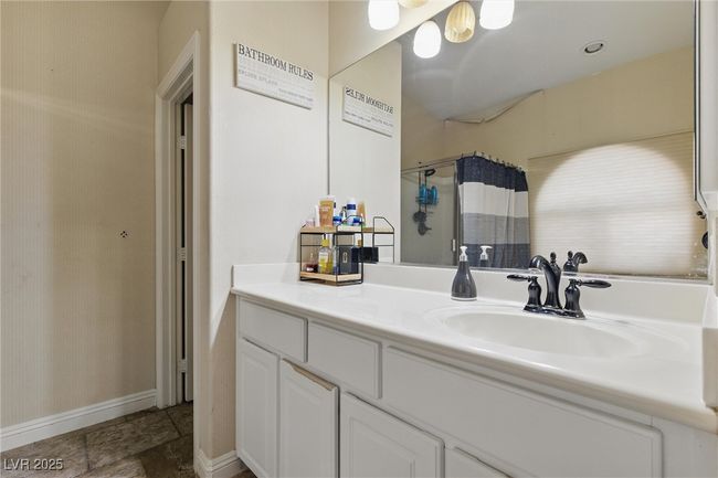 Full bath featuring vanity, baseboards, stone finish floor, and a shower with shower curtain | Image 32