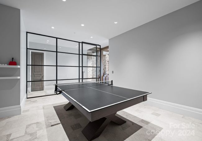 A stunning architectural grid patterned wall with glass and a custom-made ping pong table. | Image 31