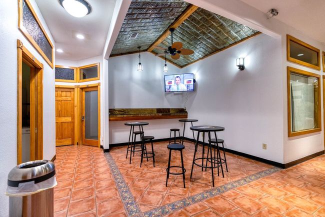 Tiled dining space featuring ceiling fan and lofted ceiling | Image 6