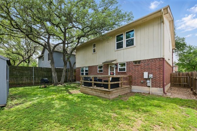 The serene outdoor space is shaded by mature trees, creating an ideal environment for peaceful outdoor living. | Image 30