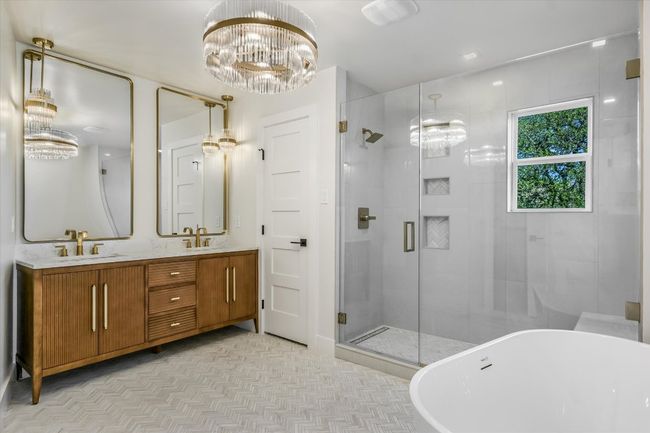 Double vanity with tub and oversized shower; large walk-in closet. | Image 10