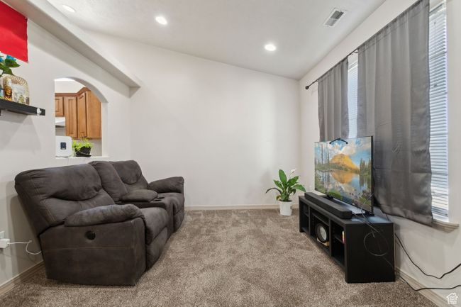 Living area with carpet flooring, recessed lighting, arched walkways, and baseboards | Image 12