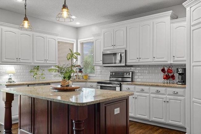 Fresh white cabinets w/stained island | Image 7