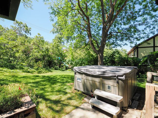 View of grassy yard featuring a hot tub | Image 74