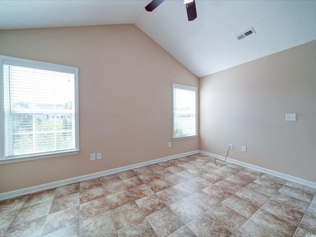 Unfurnished room featuring vaulted ceiling and ceiling fan | Image 15