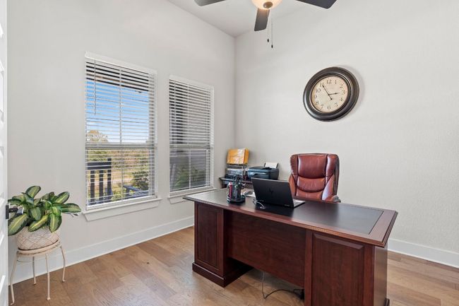Office area with ceiling fan, light wood finished floors, and baseboards | Image 7