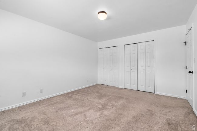 Bedroom with carpet flooring and multiple closets | Image 8