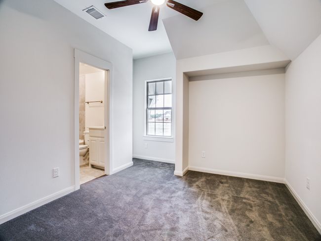 Unfurnished bedroom featuring carpet floors, a ceiling fan, and ensuite bath | Image 18