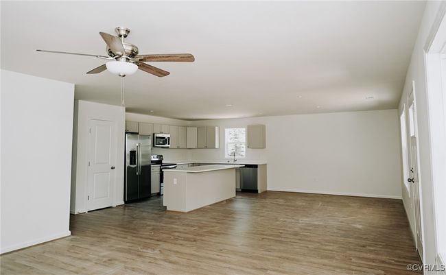 Kitchen featuring a kitchen island, light hardwood / wood-style floors, ceiling fan, and appliances with stainless steel finishes | Image 6