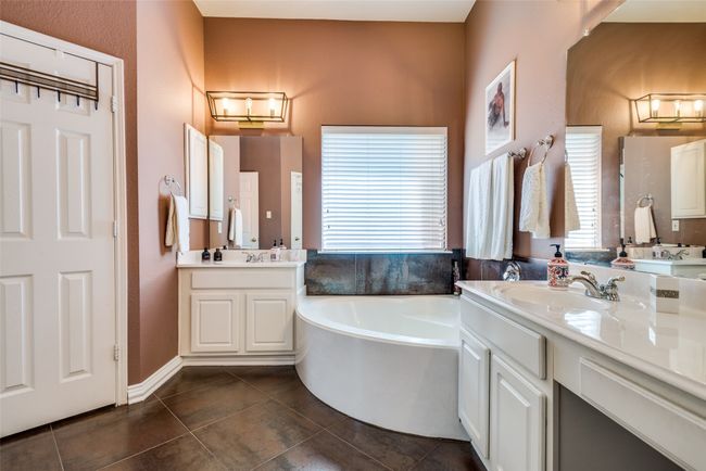 Primary bathroom also features dual vanities and a private water closet. | Image 18