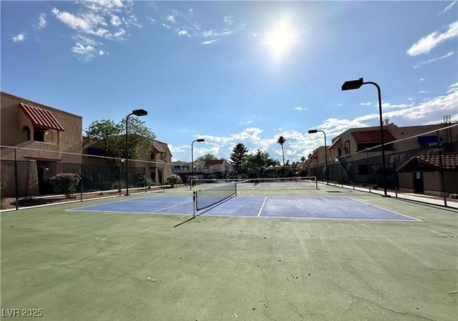 View of tennis court featuring a residential view | Image 17