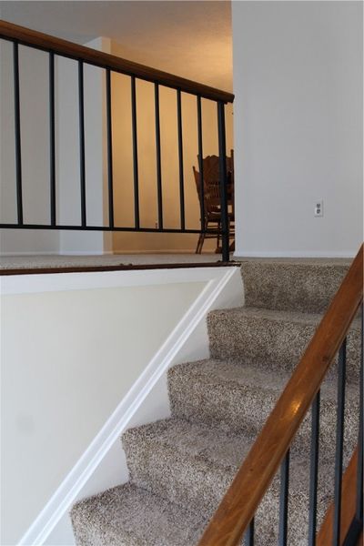 Wrought iron & wood railing- New carpeting & freshly painted interior greet you at the front Entryway | Image 2