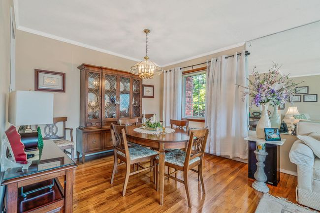 Dining area featuring a chandelier, ornamental molding, and light wood-style flooring | Image 7