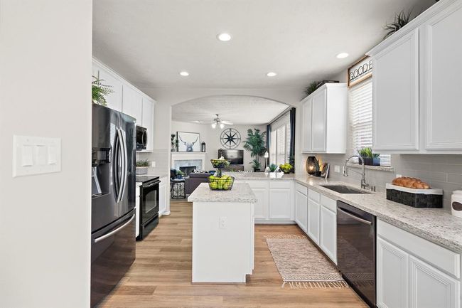 Another view of kitchen opening to family room. | Image 12