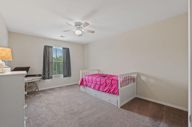 The 3rd of the secondary bedrooms overlooks the front driveway. | Image 36