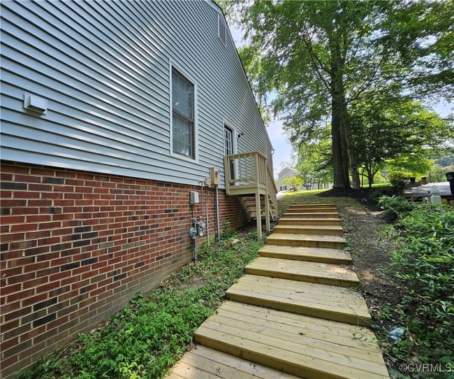 View of property side steps up to garge/pedestrian door access | Image 4