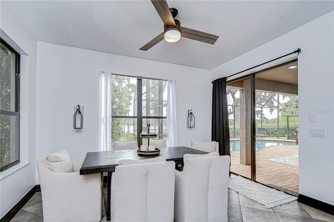 Kitchen features a bright breakfast nook—offering panoramic views of the backyard and water! | Image 12