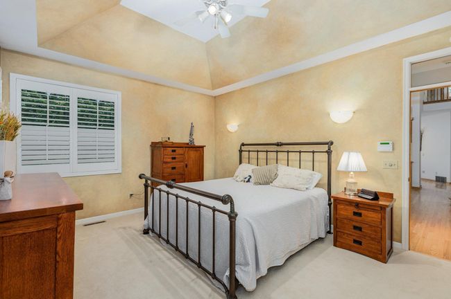 Primary Suite on main floor has bayed ceiling and plantation shutters | Image 21