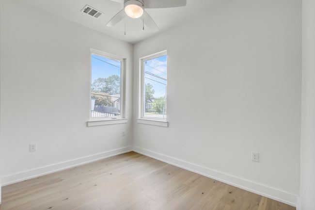 Spare room featuring ceiling fan, baseboards, and light wood finished floors | Image 22