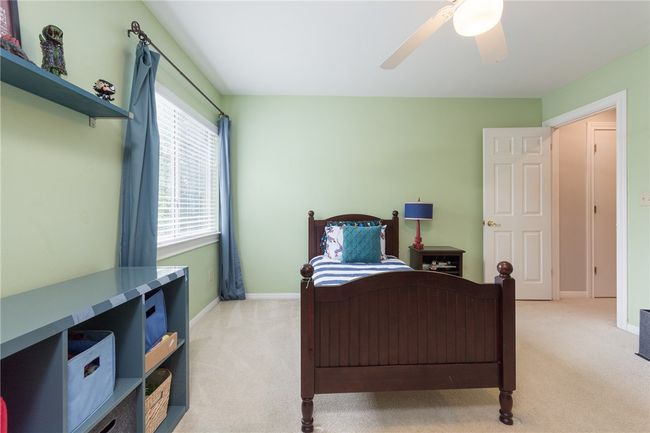 Bedroom with light colored carpet and ceiling fan | Image 23