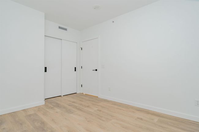 Unfurnished room with light wood finished floors, visible vents, and baseboards | Image 23