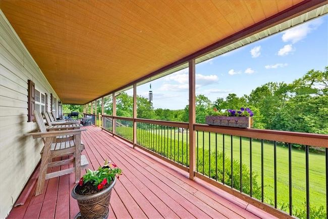 Wooden terrace featuring a lawn | Image 5