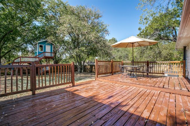 Wooden terrace with outdoor dining space and a fenced backyard | Image 22