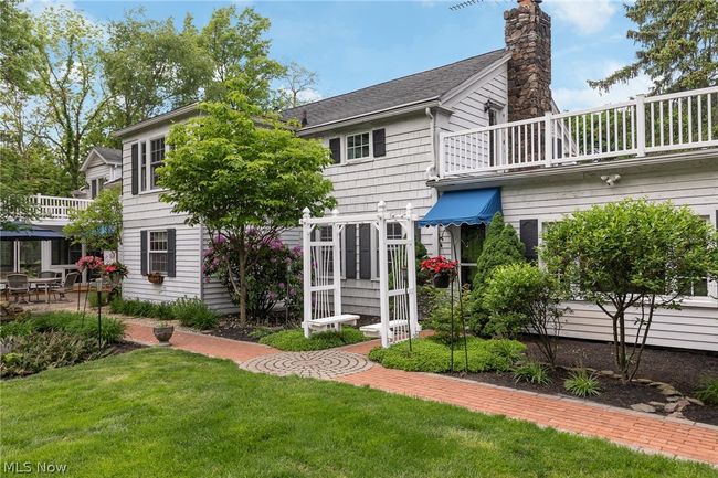 Rear view of house with a yard and a balcony | Image 14