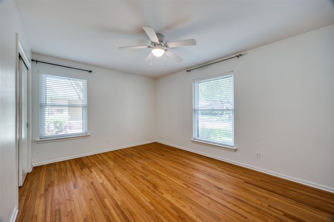 Spare room with light wood-type flooring and a ceiling fan | Image 6