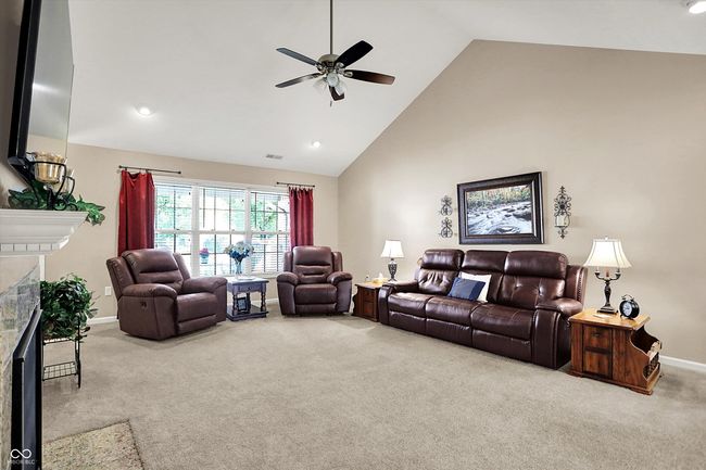 Generously sized living room bathed in natural sunlight. | Image 9