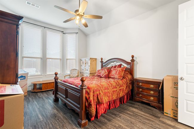 Bedroom featuring ceiling fan, dark hardwood / wood-style floors, and vaulted ceiling | Image 15