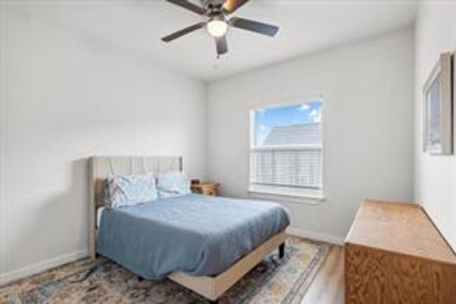 Bedroom featuring ceiling fan and baseboards | Image 15
