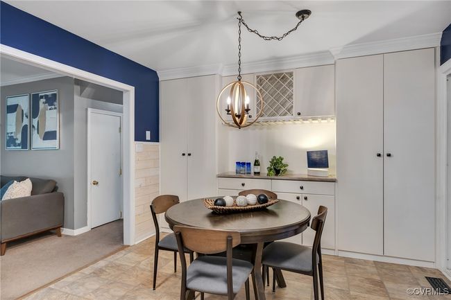 Updated Eat-in kitchen, with crown molding, custom built-in pantry and bar area, new lighting, with extra storage, quartzite countertops. | Image 11