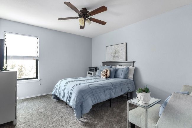 Carpeted bedroom with ceiling fan and baseboards | Image 27