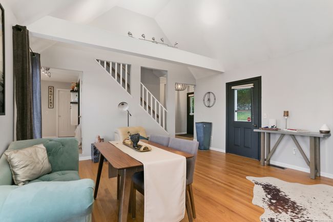 The living room is ample enough for a dining area. | Image 8