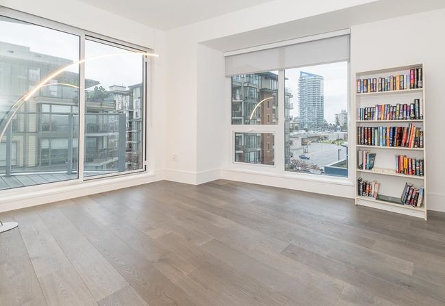 Spare room with a city view, baseboards, and wood finished floors | Image 18
