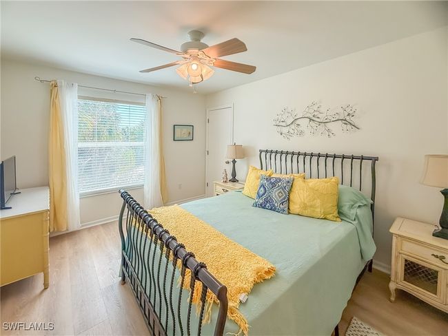 Bedroom with ceiling fan, wood finished floors, and baseboards | Image 39