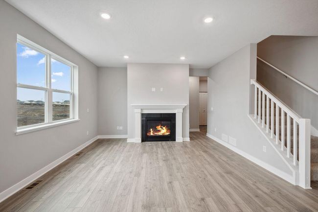 Spacious living room with electric fireplace (not shown). Model photo. Options and colors will vary. | Image 15