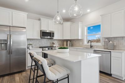 (*Photo of decorated model, actual homes colors and finishes will vary) Open and inviting throughout, the stunning kitchen will be the focal point of gatherings for years to come. | Image 2