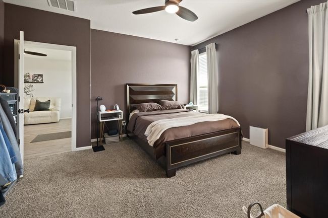 Carpeted bedroom featuring baseboards and ceiling fan | Image 21