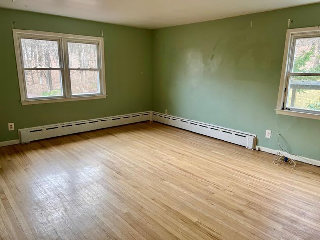 Unfurnished room featuring a baseboard radiator, hardwood / wood-style flooring, and baseboards | Image 17