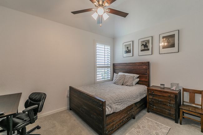 Carpeted bedroom featuring an office area and a ceiling fan | Image 24