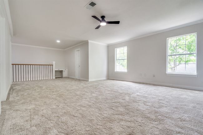 Carpeted empty room featuring crown molding and ceiling fan | Image 25