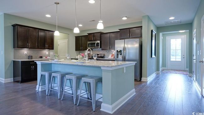 Kitchen featuring stainless steel appliances, dark brown cabinetry, baseboards, and recessed lighting | Image 4